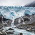 Meltwater streams flowing from a Himalayan glacier into a rocky river valley, illustrating glacier melting and flood risk.