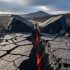 Ground-level view of an active Earth transform fault with offset rock blocks and a narrow hot fissure across rugged volcanic terrain under dramatic daylight.